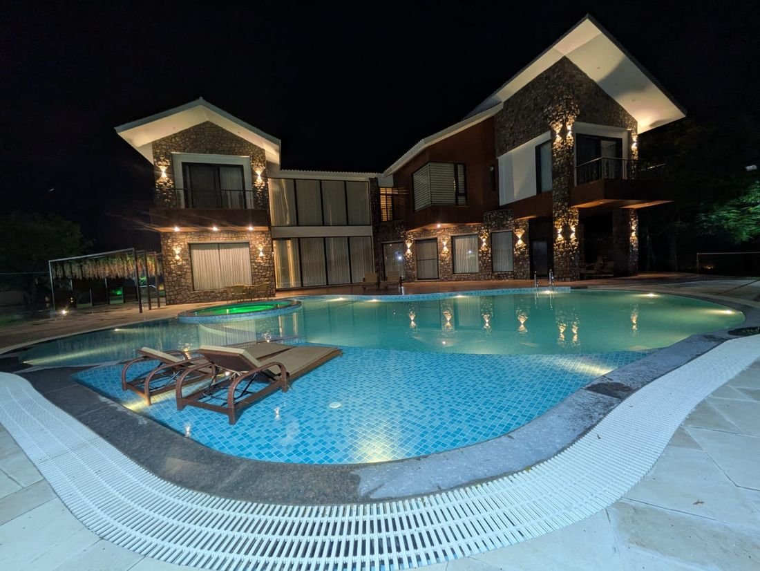 The floodlit lagoon pool at Palmwood Hills after dark