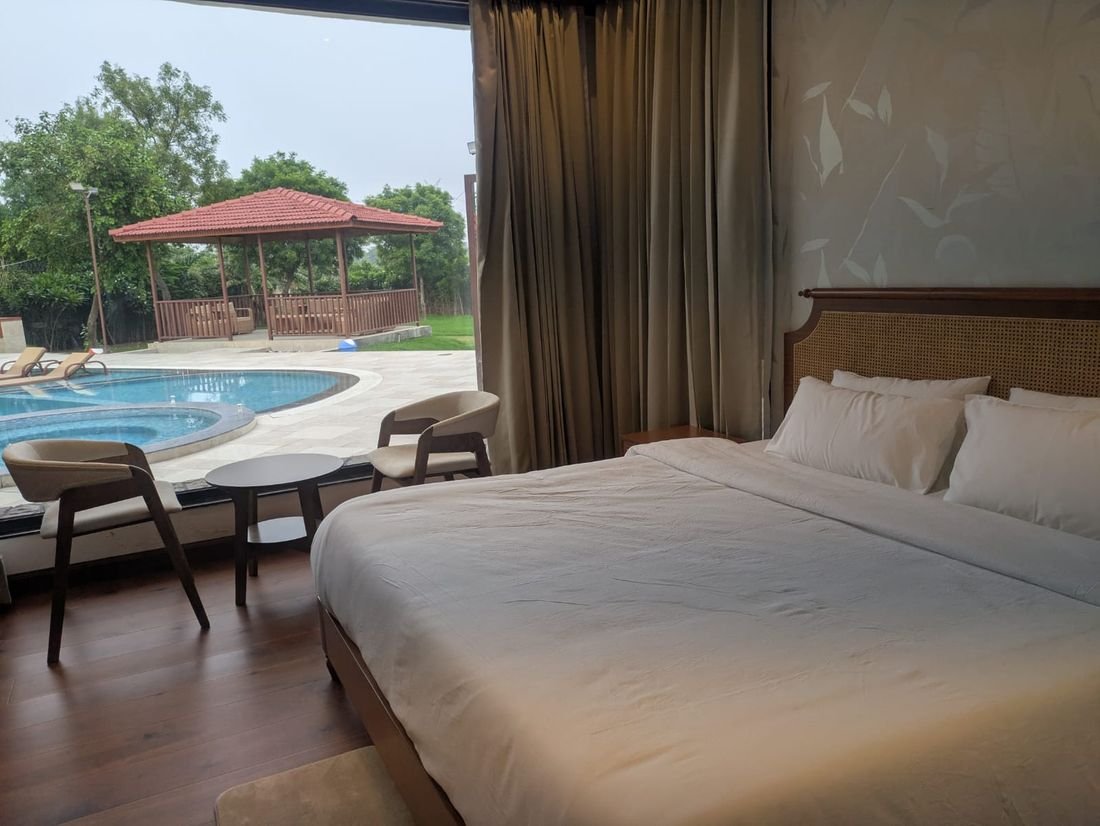 A suite at Palmwood Hills with herringbone teak floors and views onto the lawn