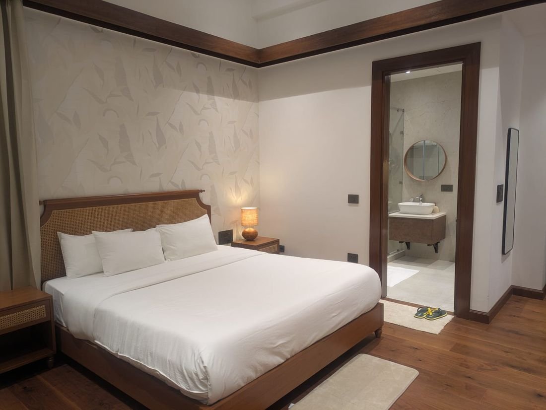A suite at Palmwood Hills with cane headboard and woven wall panelling
